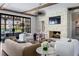 Comfortable living room features stone fireplace, exposed beams, and a view to the patio at 5495 Mount Vernon Pkwy, Atlanta, GA 30327