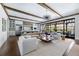 Open-concept living space with exposed beams, large glass doors, and designer furnishings at 5495 Mount Vernon Pkwy, Atlanta, GA 30327