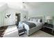 Bright bedroom featuring a queen bed, bench, and hardwood floors with blue accent at 5495 Mount Vernon Pkwy, Atlanta, GA 30327