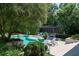 A private backyard pool area featuring lounge chairs and lush landscaping creating a serene and inviting retreat at 5495 Mount Vernon Pkwy, Atlanta, GA 30327