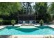 Inviting pool area with a water feature and a poolside lounge area with stylish outdoor furniture at 5495 Mount Vernon Pkwy, Atlanta, GA 30327