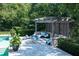 Tranquil poolside lounge area with comfortable seating, privacy shutters and lush green surroundings at 5495 Mount Vernon Pkwy, Atlanta, GA 30327