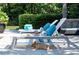 Relaxing poolside scene with lounge chairs, decorative accents, and a charming French Bulldog at 5495 Mount Vernon Pkwy, Atlanta, GA 30327