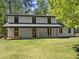 Spacious backyard featuring a covered porch with rocking chairs, perfect for outdoor relaxation at 110 Myers Dr, Alpharetta, GA 30009