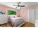 Bright bedroom with pink walls featuring a ceiling fan, hardwood floors and a window view at 110 Myers Dr, Alpharetta, GA 30009