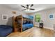bedroom featuring bunk beds, hardwood floors, a ceiling fan, and natural light from a window at 110 Myers Dr, Alpharetta, GA 30009
