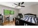 Bedroom with hardwood floors and a large window offering serene outdoor views at 110 Myers Dr, Alpharetta, GA 30009