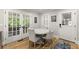 Bright eat-in kitchen with a breakfast nook, white table and chairs and access to the screened porch at 110 Myers Dr, Alpharetta, GA 30009