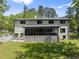 Back exterior showing a large deck with stairs and a screened-in porch at 110 Myers Dr, Alpharetta, GA 30009