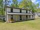 Expansive home featuring a covered porch with rocking chairs, an inviting space to relax outdoors at 110 Myers Dr, Alpharetta, GA 30009