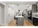 Stylish kitchen with a center island, pendant lighting, stainless steel appliances and a sliding barn door at 110 Myers Dr, Alpharetta, GA 30009