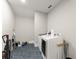 Laundry room with blue hexagon tiled floors and modern white washer and dryer at 110 Myers Dr, Alpharetta, GA 30009