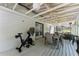 Spacious screened porch with ceiling fans, outdoor seating, and exercise equipment at 110 Myers Dr, Alpharetta, GA 30009