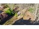 Aerial view of firepit area in backyard featuring landscaping and mature trees at 2667 White Rock Dr, Buford, GA 30519