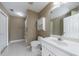 Bright bathroom with a modern vanity, large mirror, and toilet with built in shelving at 2667 White Rock Dr, Buford, GA 30519