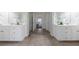 Bathroom vanity with double sinks and white cabinets, enhanced by tile flooring at 2667 White Rock Dr, Buford, GA 30519