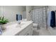 Bathroom vanity with sink and a decorative mirror, complemented by a plant and towels at 2667 White Rock Dr, Buford, GA 30519