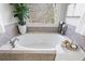 Close-up of the bathtub highlighting the tile surround and window view at 2667 White Rock Dr, Buford, GA 30519