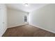 Neutral bedroom with carpeted floors, a window, and a white door at 2667 White Rock Dr, Buford, GA 30519