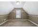 Angle shot of walk in closet with neutral walls and carpet, a single window, and wire shelves at 2667 White Rock Dr, Buford, GA 30519
