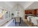 Bright dining room features a high ceiling, modern chandelier, and large windows with view of the backyard at 2667 White Rock Dr, Buford, GA 30519