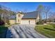 Spacious three-car garage with a long driveway at 2667 White Rock Dr, Buford, GA 30519