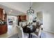 Open kitchen and dining area features cherry wood cabinets, tile floors, and view into living area at 2667 White Rock Dr, Buford, GA 30519