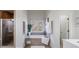 Relaxing main bathroom showcasing a soaking tub under a window and a glass-enclosed shower at 2667 White Rock Dr, Buford, GA 30519