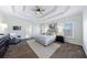 Spacious main bedroom with a tray ceiling, ceiling fan, neutral decor, and carpeted floor at 2667 White Rock Dr, Buford, GA 30519