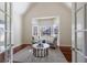 Bright sitting room with hardwood floors, area rug, two armchairs and French doors at 2667 White Rock Dr, Buford, GA 30519