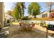 Inviting backyard with an outdoor dining set, grill, playset, and fenced yard at 302 Cimarron Way, Lawrenceville, GA 30044