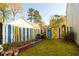 Backyard with a garden bed, colorful fence, and a shed at 302 Cimarron Way, Lawrenceville, GA 30044