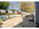 Spacious backyard with a large patio area, seating, and a colorful privacy fence at 302 Cimarron Way, Lawrenceville, GA 30044