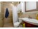 Cozy bathroom featuring a shower, toilet, and sink with vanity storage at 302 Cimarron Way, Lawrenceville, GA 30044