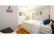 Bedroom with wood floors, light gray walls, modern lighting, and a large window at 302 Cimarron Way, Lawrenceville, GA 30044