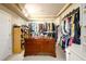Spacious walk-in closet featuring custom shelving, ample storage, and a large center island for organization at 302 Cimarron Way, Lawrenceville, GA 30044