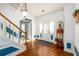 Bright foyer with hardwood floors, complemented by a staircase with colorful accents at 302 Cimarron Way, Lawrenceville, GA 30044