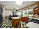 Bright eat-in kitchen with stainless steel appliances, checkered flooring, and a view of the backyard at 302 Cimarron Way, Lawrenceville, GA 30044