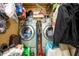 Stacked washer/dryer in the laundry area with nearby household supplies at 302 Cimarron Way, Lawrenceville, GA 30044