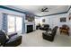 Inviting living room with a fireplace, large TV, leather furniture, and sliding doors to the outside at 302 Cimarron Way, Lawrenceville, GA 30044