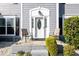 Close-up of a home's front porch with seating and decorative plants at 302 Cimarron Way, Lawrenceville, GA 30044