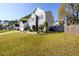 Side view of a two-story home, showcasing a well-manicured lawn and partial fencing at 302 Cimarron Way, Lawrenceville, GA 30044