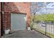 Private balcony with brick wall, metal railing, and view of parking area at 644 Wells Sw St # 8, Atlanta, GA 30310