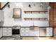 Modern kitchen features white cabinets, stainless steel appliances, and open wooden shelving at 644 Wells Sw St # 8, Atlanta, GA 30310