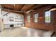 Open kitchen showcasing exposed brick, stainless steel appliances, and large windows at 644 Wells Sw St # 8, Atlanta, GA 30310