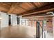 Open concept living space with wood beam ceilings and exposed brick walls at 644 Wells Sw St # 8, Atlanta, GA 30310