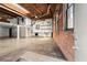 Bright open living area with exposed brick, loft, and modern kitchen details under a wood ceiling at 644 Wells Sw St # 8, Atlanta, GA 30310
