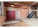 Open living area with exposed brick and black metal staircase leading to a loft space at 644 Wells Sw St # 8, Atlanta, GA 30310