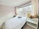 Comfortable bedroom with a large window and side storage at 6980 Roswell Rd # E1, Atlanta, GA 30328