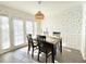 Bright dining room with a wooden table, pendant light, and large sliding doors for great natural lighting at 6980 Roswell Rd # E1, Atlanta, GA 30328